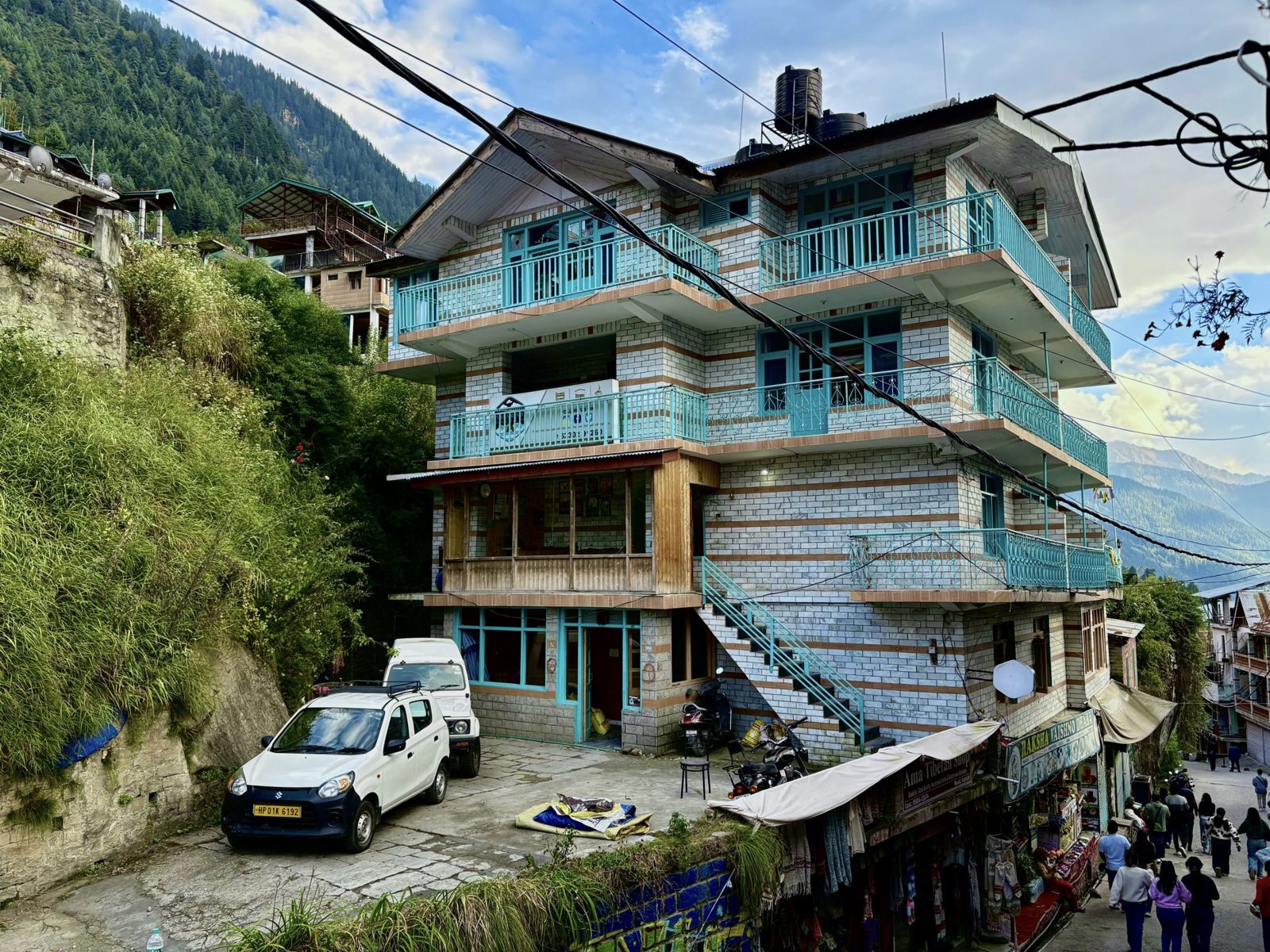 Front of the Misfits building in Vashisht, Manali, with teal balconies