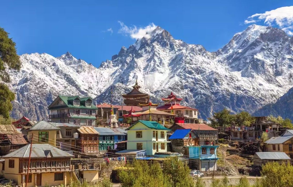 Himalayan village below snow peaks